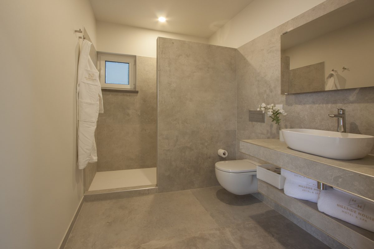 Bathroom with a walk-in rain shower, vessel basin and heated towels