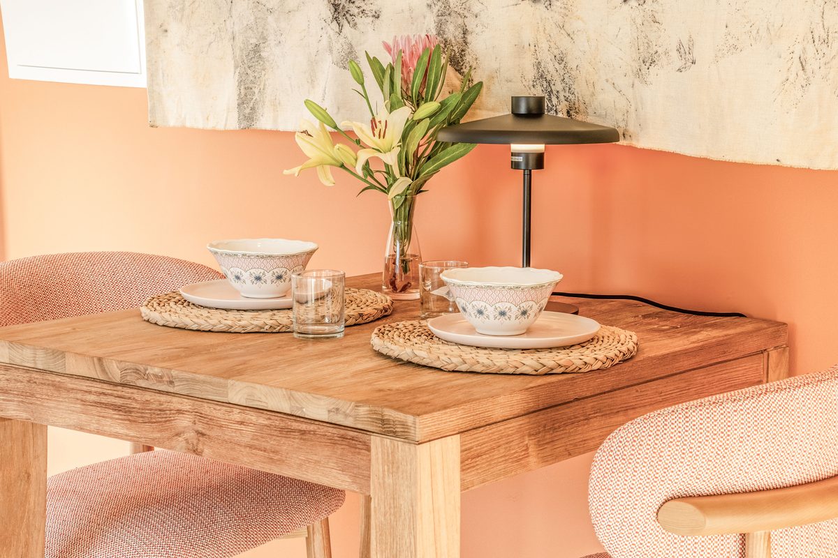 Dining table laid with flowers and cups
