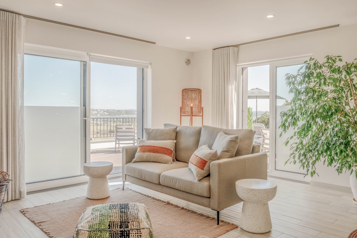 Sitting room with a pale sofa between two windows