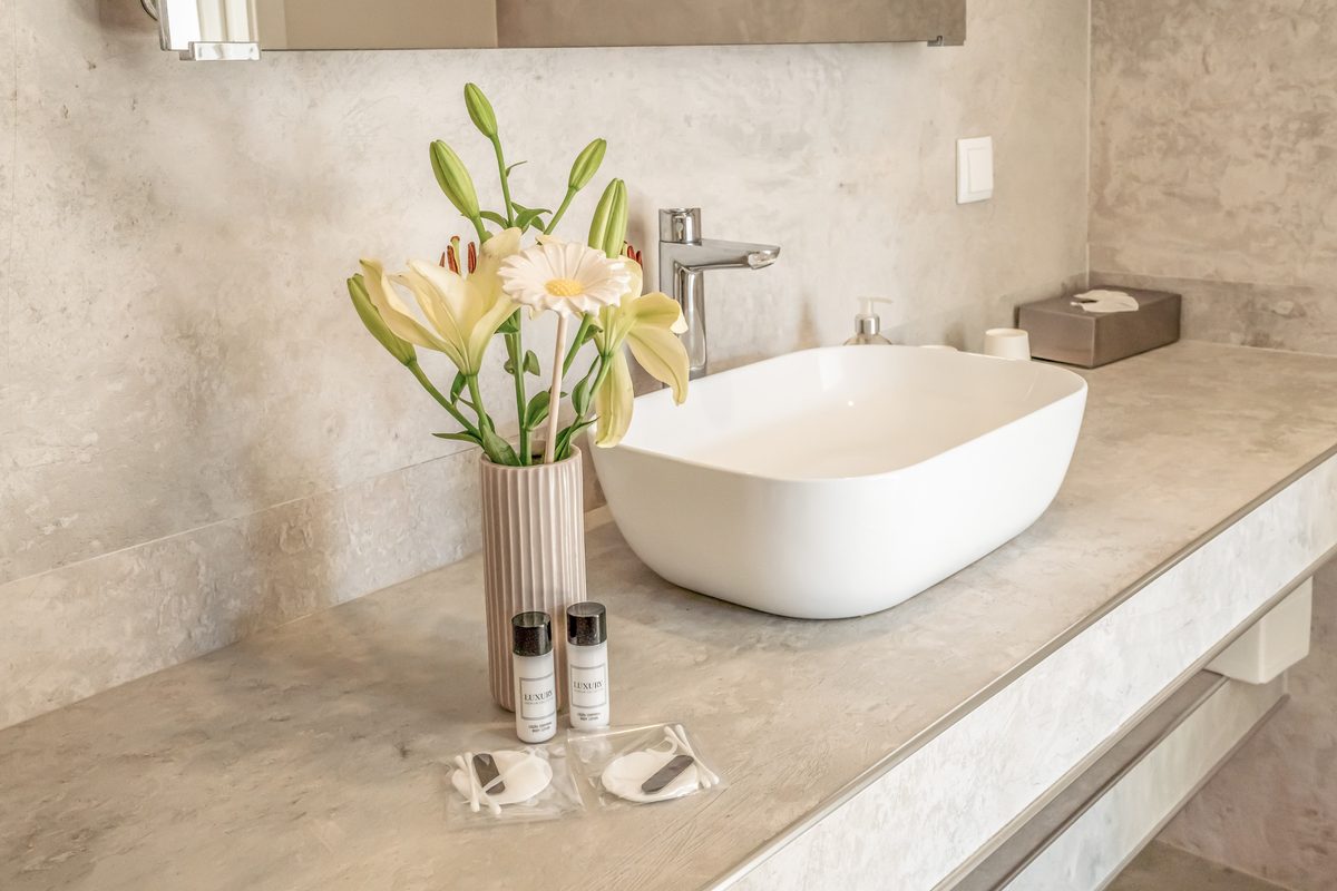 Bathroom with a vessel basin on a marble counter