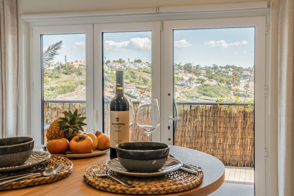 Table laid on the terrace, looking out over the hills