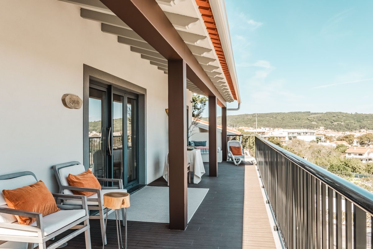 Covered terrace running the length of the apartment, loungers and a long view